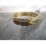 A 9ct gold bangle