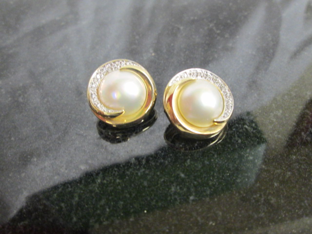 A pair of gold and pearl earrings