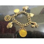 A 9ct charm bracelet with a 1912 sovereign and an 1895 half sovereign