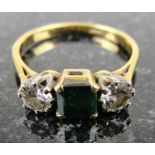 An 18ct Diamond and Emerald Ring:
Well balanced set ring with two brilliant cut diamonds and a