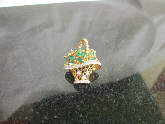 A 14k gold Emerald and Diamond basket brooch