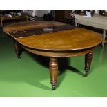 A Victorian mahogany wind out table with one extra leaf