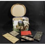 A vintage hat box containing lady's gloves and handbags