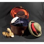A vintage hat box containing lady's hats and shoes