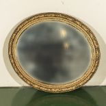 A large gilt framed oval mirror