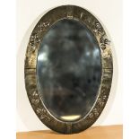 An Arts and Crafts oval embossed brass mirror