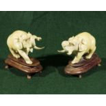 A pair of small ivory elephants, 8cm tall with stands