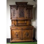 A Continental carved oak two door cupboard on base