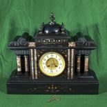 A Victorian black slate mantle clock