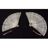 A matched pair of antique French ivory fans