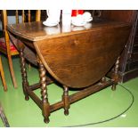 An oak gate legged table with barley sugar twist legs