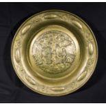 An antique brass Alm's dish depicting Adam and Eve