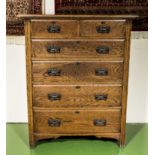 An Edwardian oak chest of two over four drawers