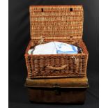 A basket and a trunk of vintage linen