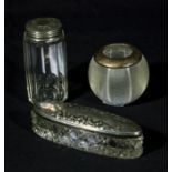 Three silver lidded glass containers