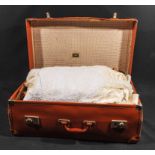 A suitcase of vintage linen and two wedding dresses