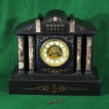 A Victorian black slate mantle clock