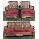 A walnut framed bergere three seater sofa and two matching arm chairs