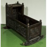 A carved oak cradle