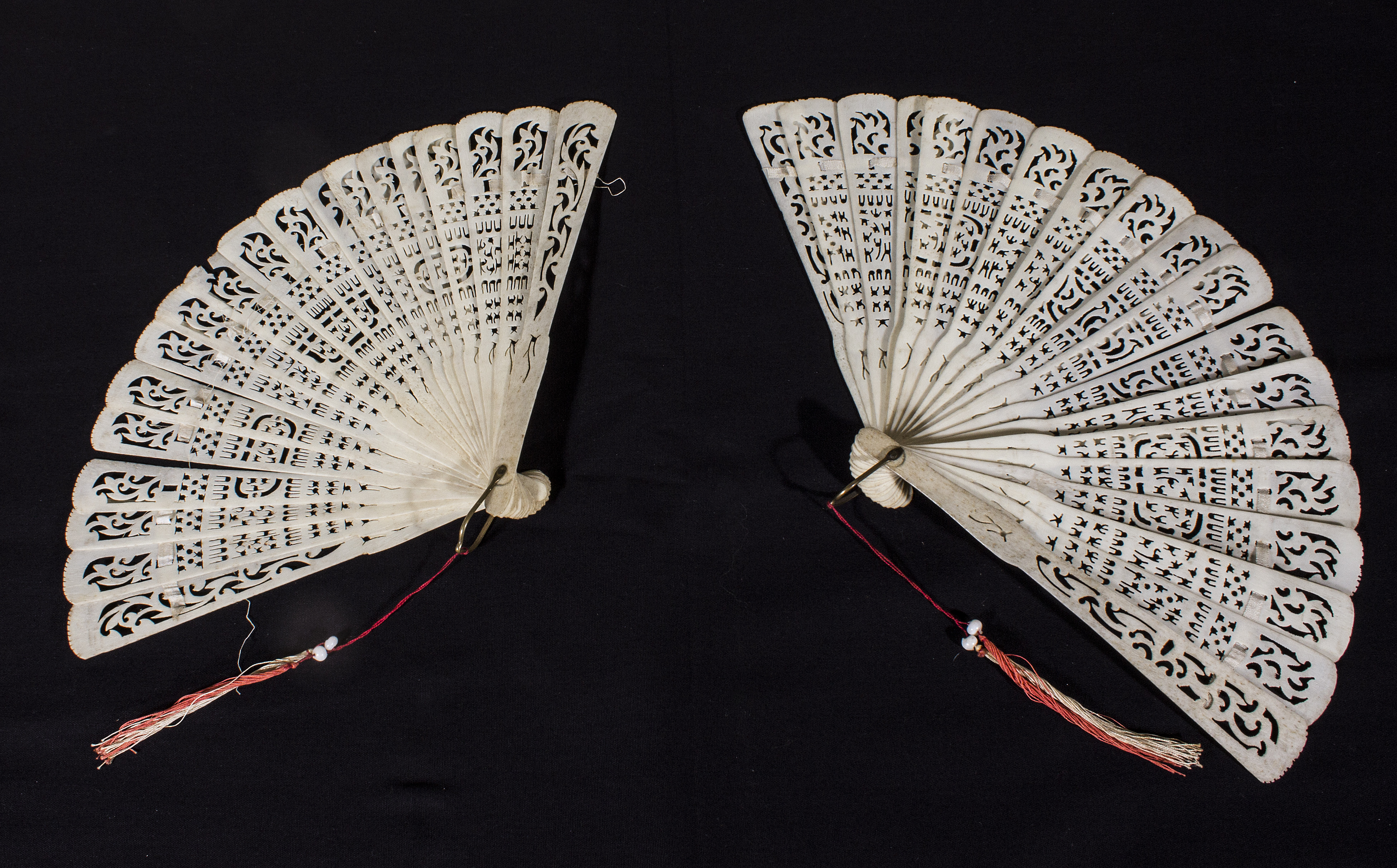 A matched pair of antique French ivory fans