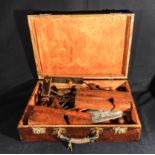 A wooden case containing vintage tools