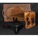 A carved wooden tray, elephant and three others