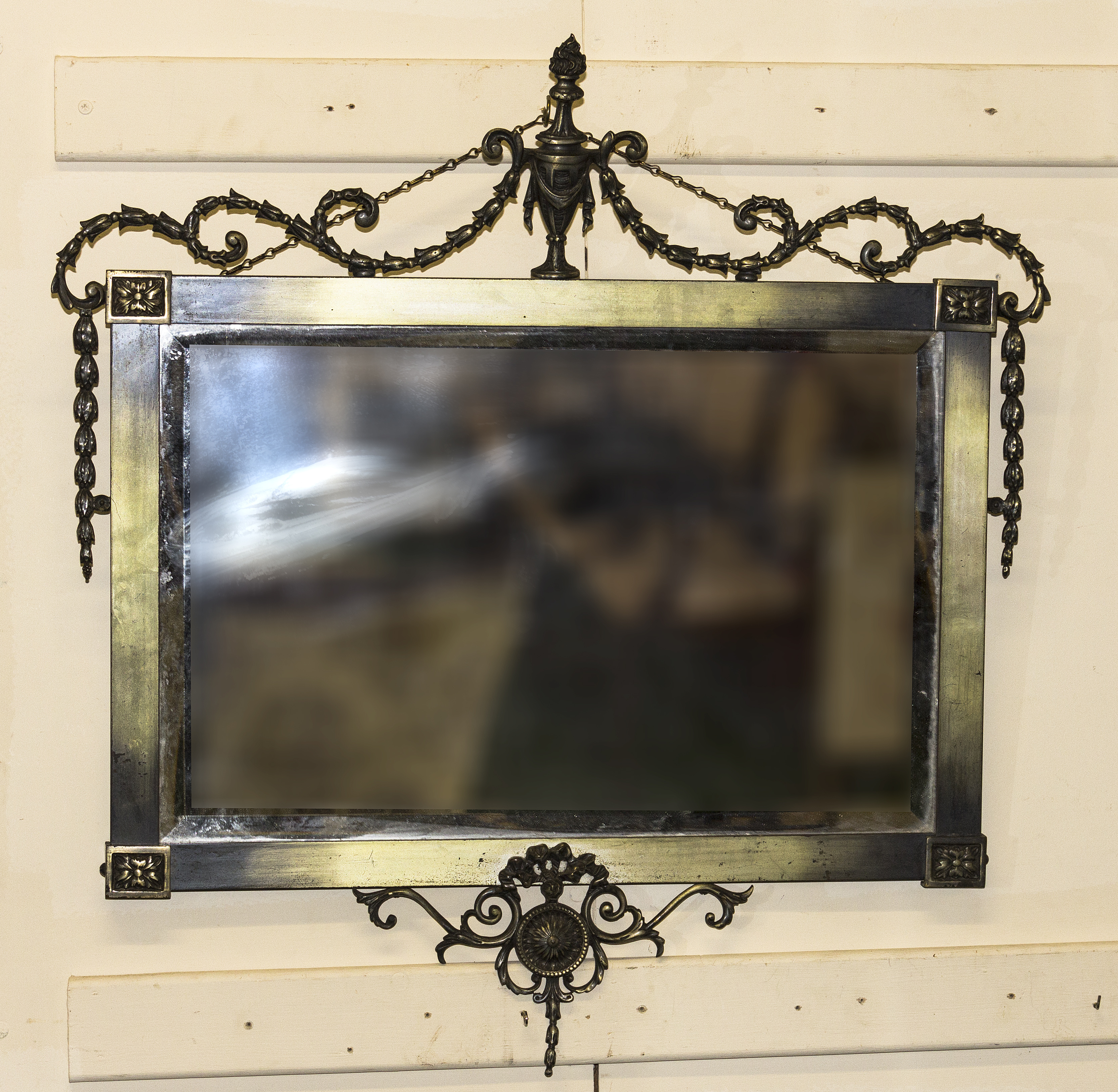 An Edwardian Adam's style brass framed mirror