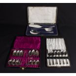 Two cased sets of teaspoons and a cased set of cake servers