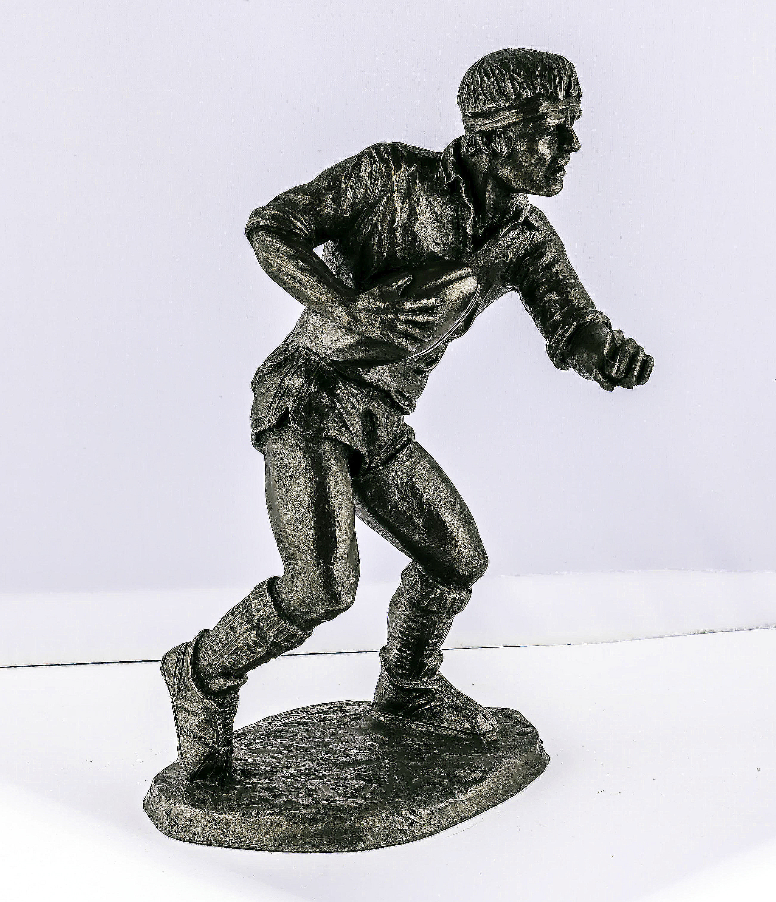 A cold cast resin bronze of a rugby player