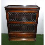 A Wernicke bookcase in oak with leaded glass doors and drawer to base .2 ft 10inch wide .3 ft 4 inch