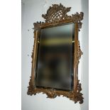 An early 19th century carved walnut framed mirror