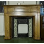 A pine painted fire place with cast iron and tiled insert.