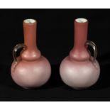 A pair of pink satin glass bottle shaped vases, 15cm tall