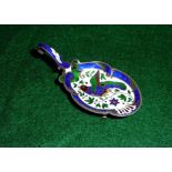 A silver spoon with enamel decoration