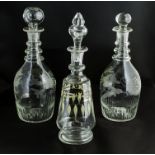 Two etched glass wine carafes and one other