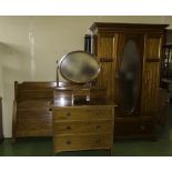 An Edwardian inlaid mahogany robe, dressing table and bed.