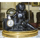 A good quality French bronze cherub clock on gilded base. 1 ft 10 inch wide, 1 ft 6 inch tall.