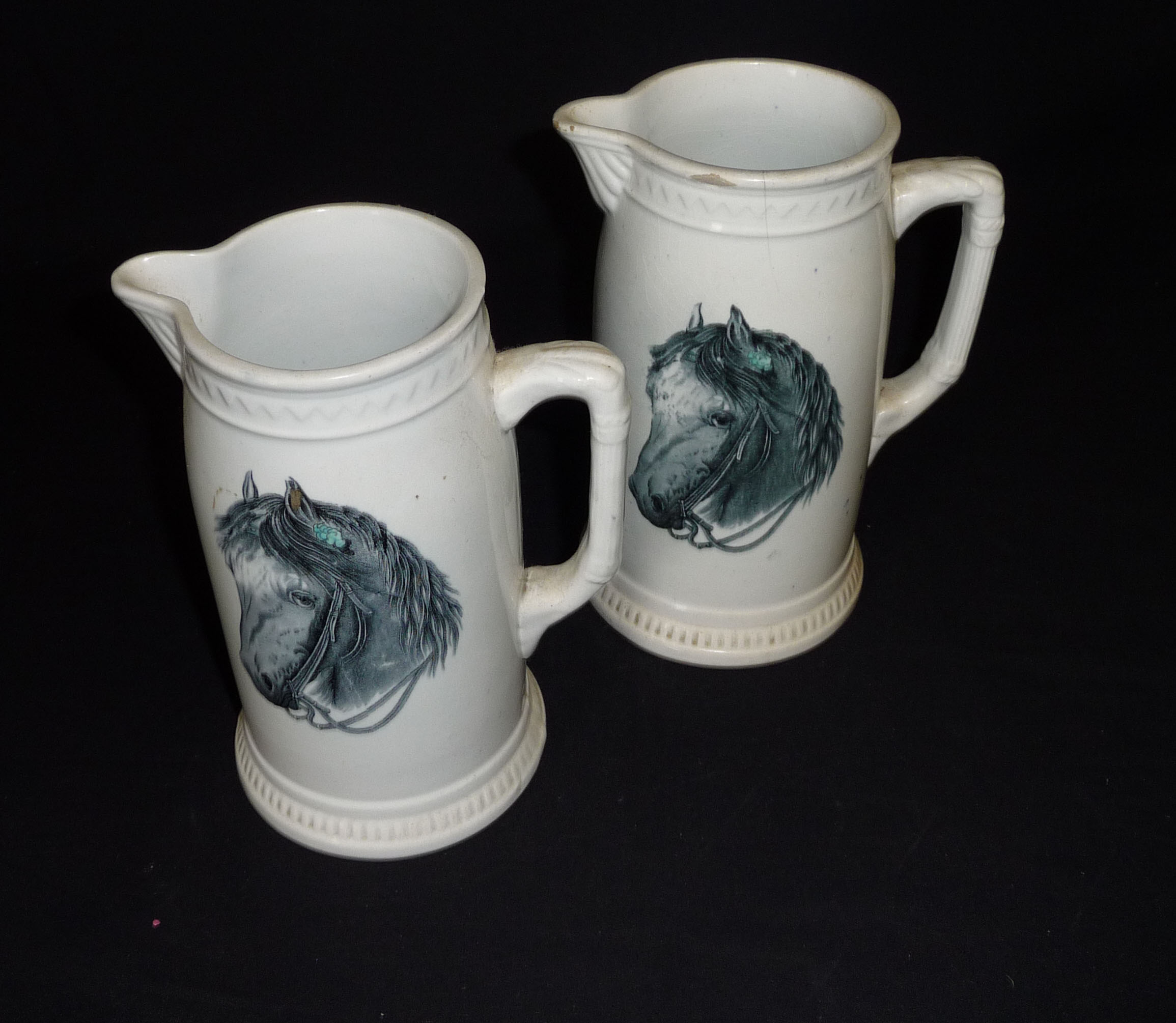 Two Staffordshire pottery jugs with horse decoration, 21cm tall