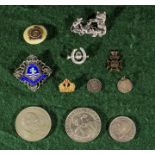 Five coins together with six badges