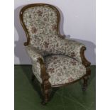 A Victorian upholstered spoon backed armchair