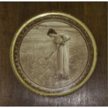 An oak and gilt framed print of a girl picking flowers..