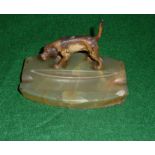 A cold painted bronze dog on an onyx ashtray