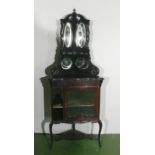 A Victorian mahogany corner cabinet with mirrored back