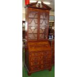 A good quality 1970 copy on a Georgian inlaid mahogany bureau bookcase with a shaped and stepped