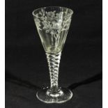 An etched wine glass with faceted stem