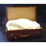 A vintage suitcase containing nightgowns and petticoats