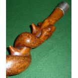 An Australian carved wood walking stick with entwined snake and silver top