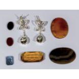 A collection of gemstones and a pair of silver earrings