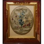 A gilt framed silk needlework in a rosewood frame