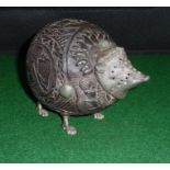 A carved coconut shell silver mounted desk sander modelled as a hedgehog